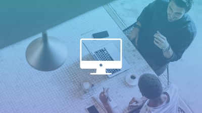 Top-down view of a woman and a man at a work desk with a laptop in the middle