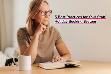 Woman at a desk with a book, resting her chin on her hand