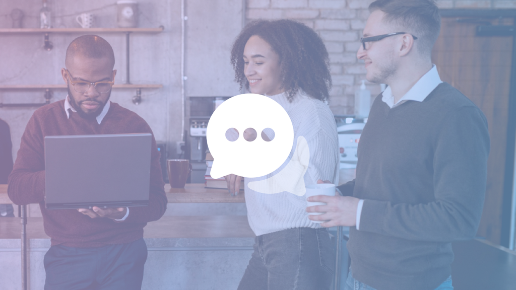 Three employees gathered around in conversation