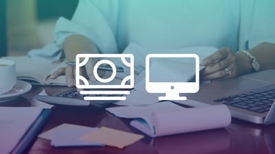 Close up of a person's hands looking through paper documents and typing on a calculator