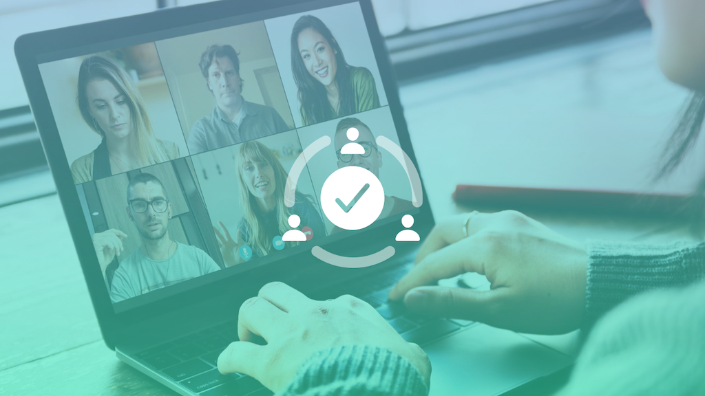 Hands typing on a laptop with the screen displaying a video conference