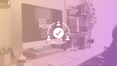 A monitor on a desk, displaying the words 'do more'