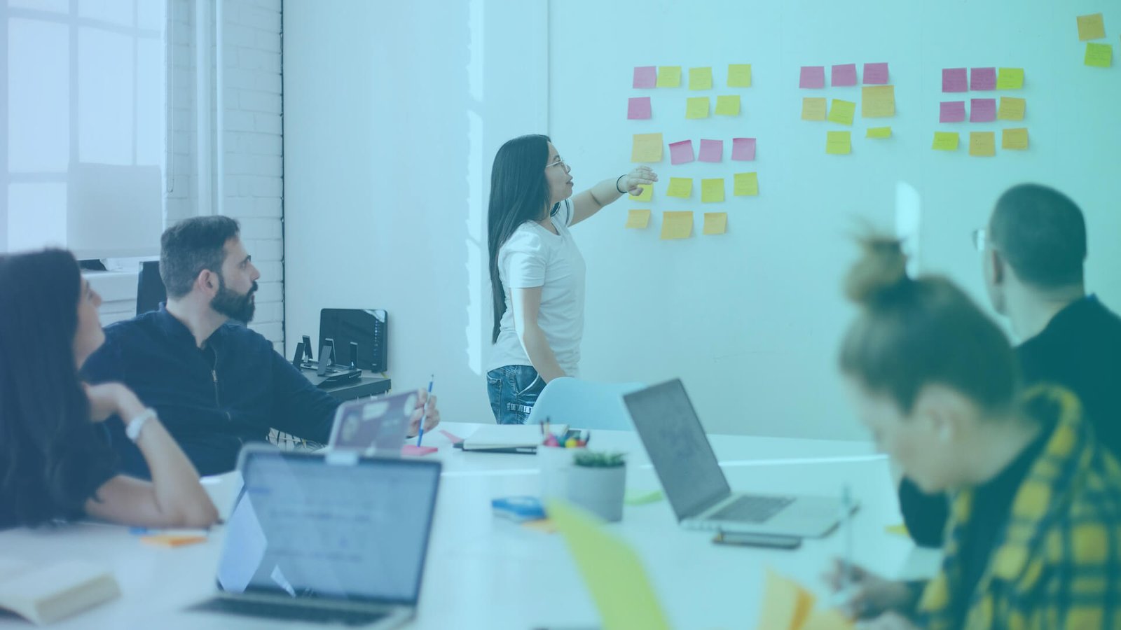 A team discussing change management best practices to help improve their new process implementation