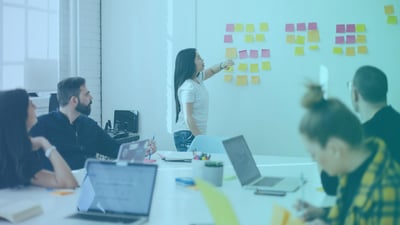 A team discussing change management best practices to help improve their new process implementation