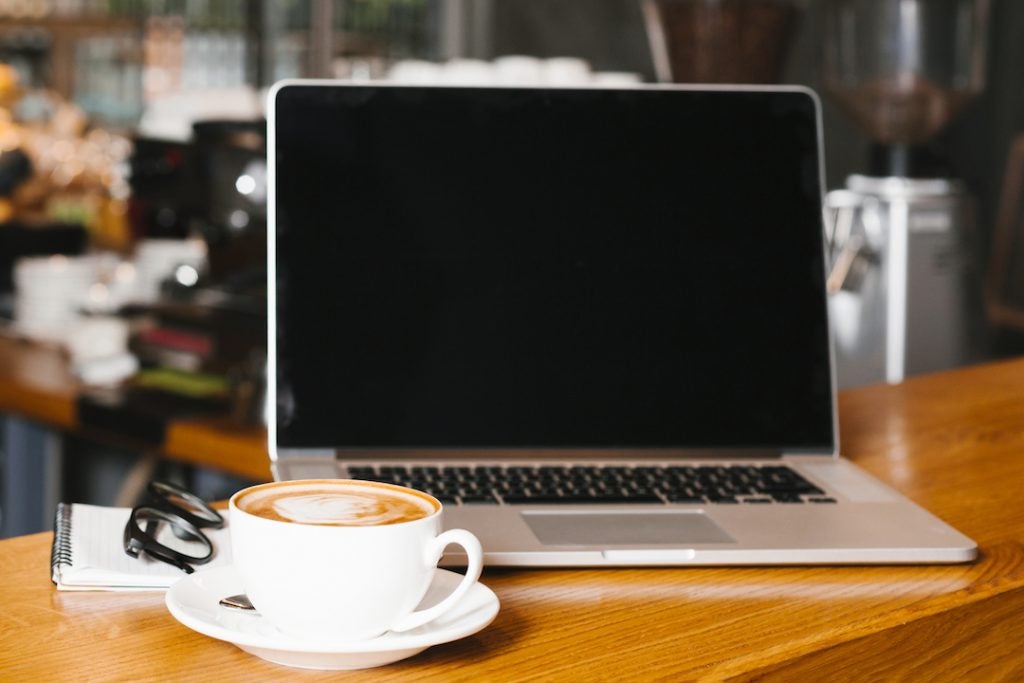 laptop-and-coffee-on-desk-in-cafe