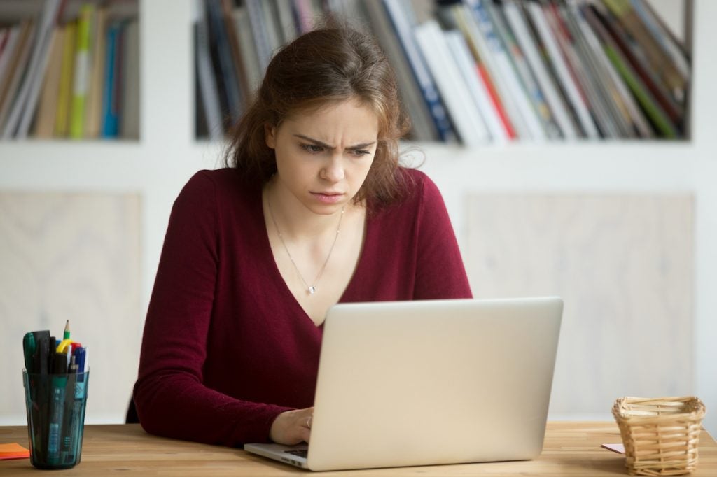 woman-looking-confused-working-from-home-with-laptop